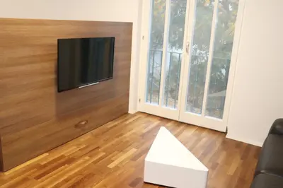 a living room with a flat screen tv on a wall at Studio apartma Terme Ptuj in Ptuj