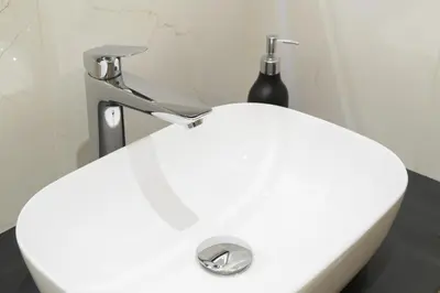 a white sink with a faucet in a bathroom at ROYAL SUITE, Ljubljana in Ljubljana