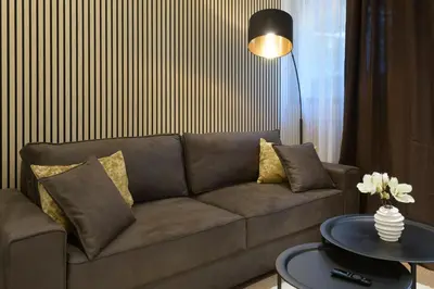 a living room with a couch and a table at ROYAL SUITE, Ljubljana in Ljubljana