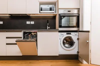 a kitchen with a dishwasher and a washer at Vina Kobal, Kobal Family Estate in Štanjel