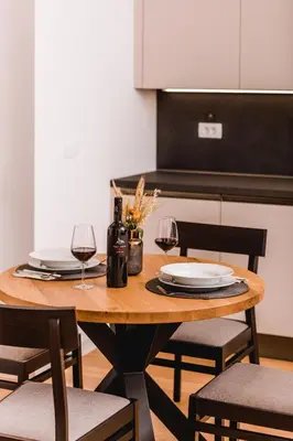 a wooden table with two glasses of wine at Vina Kobal, Kobal Family Estate in Štanjel