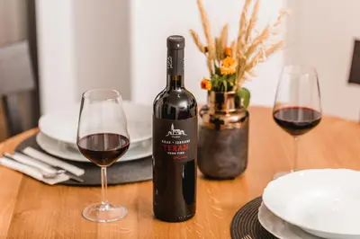 a bottle of wine and two glasses on a table at Vina Kobal, Kobal Family Estate in Štanjel