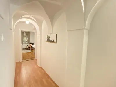a hallway with white walls and an archway at Villa pod Gradom in Ljubljana