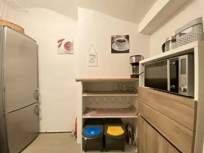 a kitchen with a refrigerator and some bins at Villa pod Gradom in Ljubljana