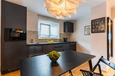 a kitchen with a dining room table and a chandelier at Vila Valentina in Ljubljana