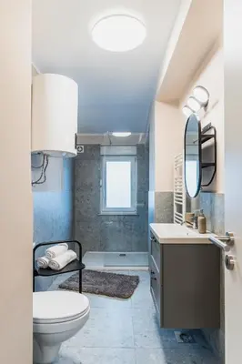 a bathroom with a toilet and a sink and a mirror at Vila Valentina in Ljubljana