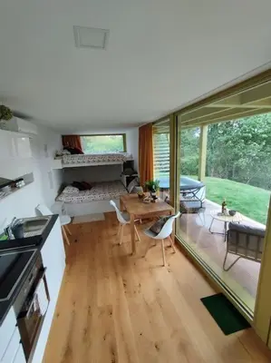 a kitchen and dining room with a table and chairs at Holiday house Hona Lux in Velike Lašče