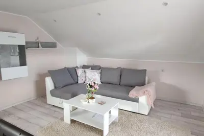 a living room with a couch and a table at Veronika's House je prijeten, miren apartma v naravi, blizu mesta in Celje