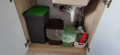 a bathroom with two trash cans and a sink at Veronika's House je prijeten, miren apartma v naravi, blizu mesta in Celje