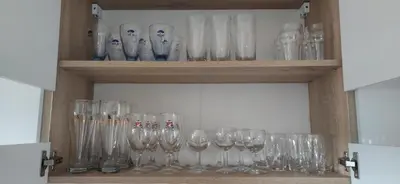 a shelf filled with lots of empty wine glasses at Veronika's House je prijeten, miren apartma v naravi, blizu mesta in Celje