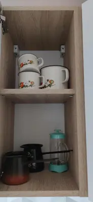 a wooden shelf with cups and dishes on it at Veronika's House je prijeten, miren apartma v naravi, blizu mesta in Celje