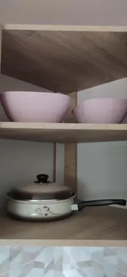 a kitchen shelf with bowls and a pot on it at Veronika's House je prijeten, miren apartma v naravi, blizu mesta in Celje