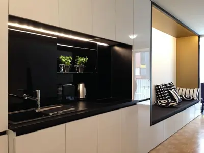a kitchen with a black and white counter top at Gorgeous central flat with garage in Ljubljana
