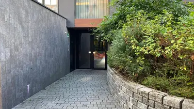 a hallway leading to a building with a door at Gorgeous central flat with garage in Ljubljana