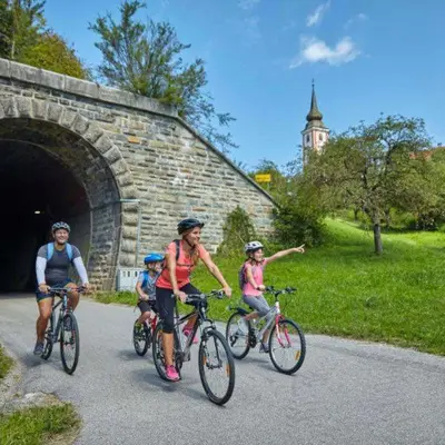 a group of people riding bikes down a road at F95 AQUALUNA KAMP NATURA PODČETRTEK swimming card not included in Podčetrtek