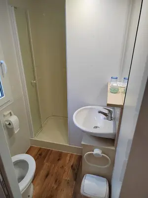 a small bathroom with a sink and a toilet at F95 AQUALUNA KAMP NATURA PODČETRTEK swimming card not included in Podčetrtek