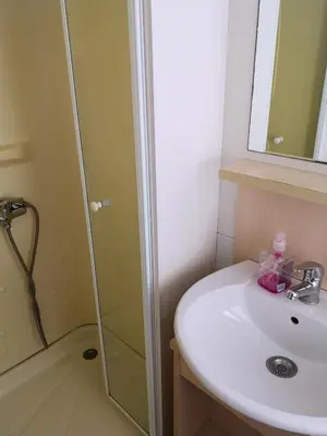 a bathroom with a sink and a shower at F95 AQUALUNA KAMP NATURA PODČETRTEK swimming card not included in Podčetrtek