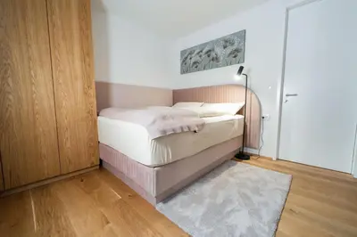 a small bedroom with a bed with a lamp at Bor in Bor Luxury Apartment with sauna & garden - Kranjska Gora in Kranjska Gora