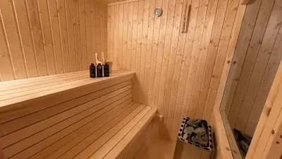 a wooden sauna with three bottles in it at Bor in Bor Luxury Apartment with sauna & garden - Kranjska Gora in Kranjska Gora