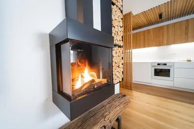 a fireplace in a living room with a fire in it at Bor in Bor Luxury Apartment with sauna & garden - Kranjska Gora in Kranjska Gora