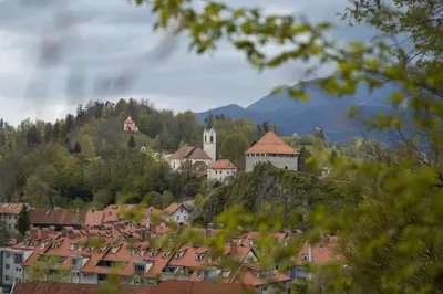 a town on a hill with houses and a church at Vacation Station Kamnik in Kamnik