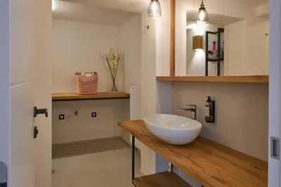a bathroom with a white bowl sink on a counter at Vacation Station Kamnik in Kamnik