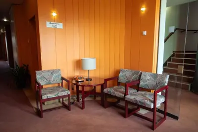 a room with two chairs and a table with a lamp at MC Hotel in Žalec