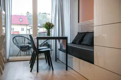 a bedroom with a desk and a bed and a window at Sunny home with cute dragon in the center+parking in Ljubljana
