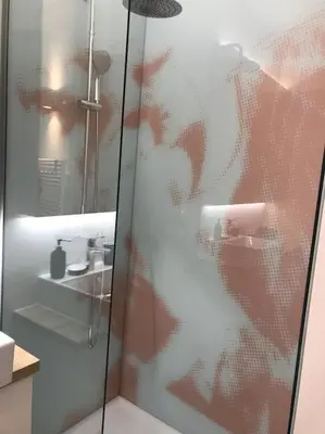 a shower with a glass door in a bathroom at Sunny home with cute dragon in the center+parking in Ljubljana