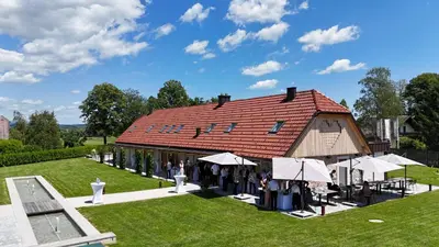 a group of people standing in front of a barn at Resort Village Majer - Apartments, Glamping - Slovenia in Gradac