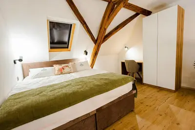 a bedroom with a large bed in a room at Resort Village Majer - Apartments, Glamping - Slovenia in Gradac