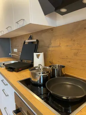 a kitchen with a stove with pots and pans on it at Apartments Naklo in Naklo