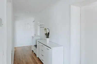 a white dressing room with a white dresser at Apartments Naklo in Naklo