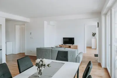 a living room with a table and a couch at Apartments Naklo in Naklo