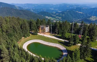 an aerial view of a lake in the mountains at Apartment & Studio Forest Paradise in Cerkno