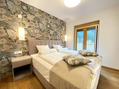 a bedroom with a bed with two pillows on it at Lux Apartment Ski&Golf in Kranjska Gora