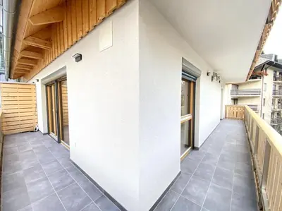 an empty balcony of a building with a white wall at Lux Apartment Ski&Golf in Kranjska Gora
