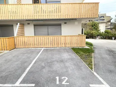 a parking lot in front of a house at Lux Apartment Ski&Golf in Kranjska Gora