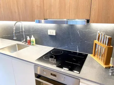 a kitchen with a stove and a sink at Lux Apartment Ski&Golf in Kranjska Gora