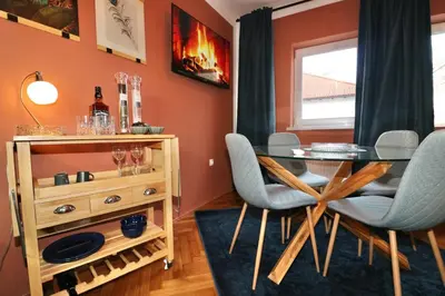 a dining room with a glass table and chairs at Studio City in Ljubljana