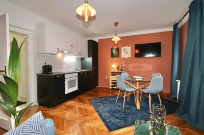 a living room with a table and chairs at Studio City in Ljubljana