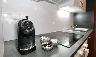 a kitchen with a coffee maker on a counter at Studio City in Ljubljana