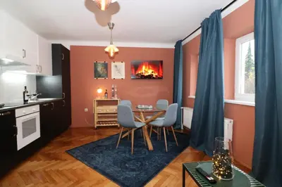 a kitchen and dining room with a table and chairs at Studio City in Ljubljana