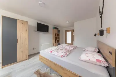 a bedroom with a bed with two pillows on it at Apartma Naravni biser in Brezje