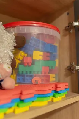 a plastic container filled with legos on a shelf at Apartma Naravni biser in Brezje