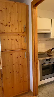 a kitchen with wooden cabinets and a stove at Apartment Katrca Kranjska Gora in Kranjska Gora