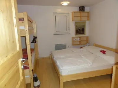 a bedroom with a bunk bed and a ladder at Apartment Katrca Kranjska Gora in Kranjska Gora