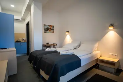 a bedroom with a large bed in a room at Villa Magdalena apartments & rooms GARNI HOTEL in Maribor