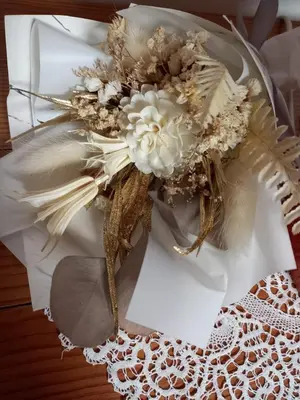 a white bouquet of flowers on a table at Riverside Villa Avo - Apartment Martin in Spodnja Idrija