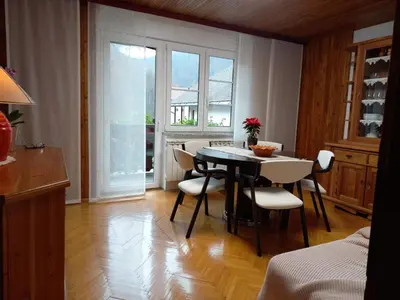 a kitchen with a table and chairs in a room at Riverside Villa Avo - Apartment Martin in Spodnja Idrija